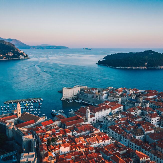 Breathtaking sunset over Dubrovnik's historic cityscape and Adriatic coast.