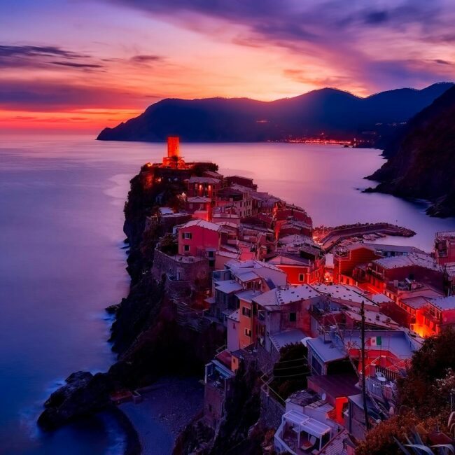 Discover the serene beauty of Vernazza during a mesmerizing sunset along Italy's Cinque Terre coast.